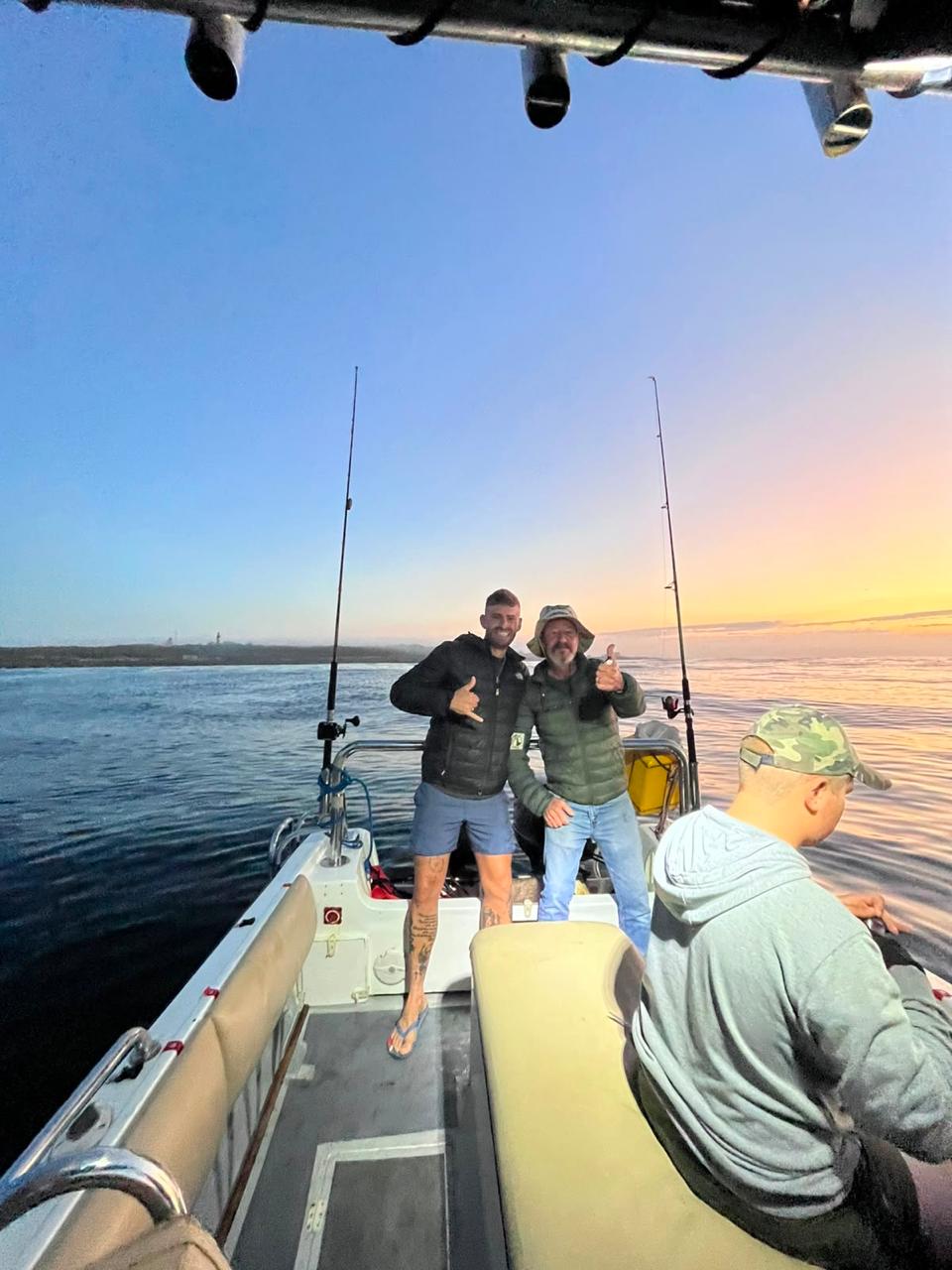 Guests on board at golden hour with fishing rods out
